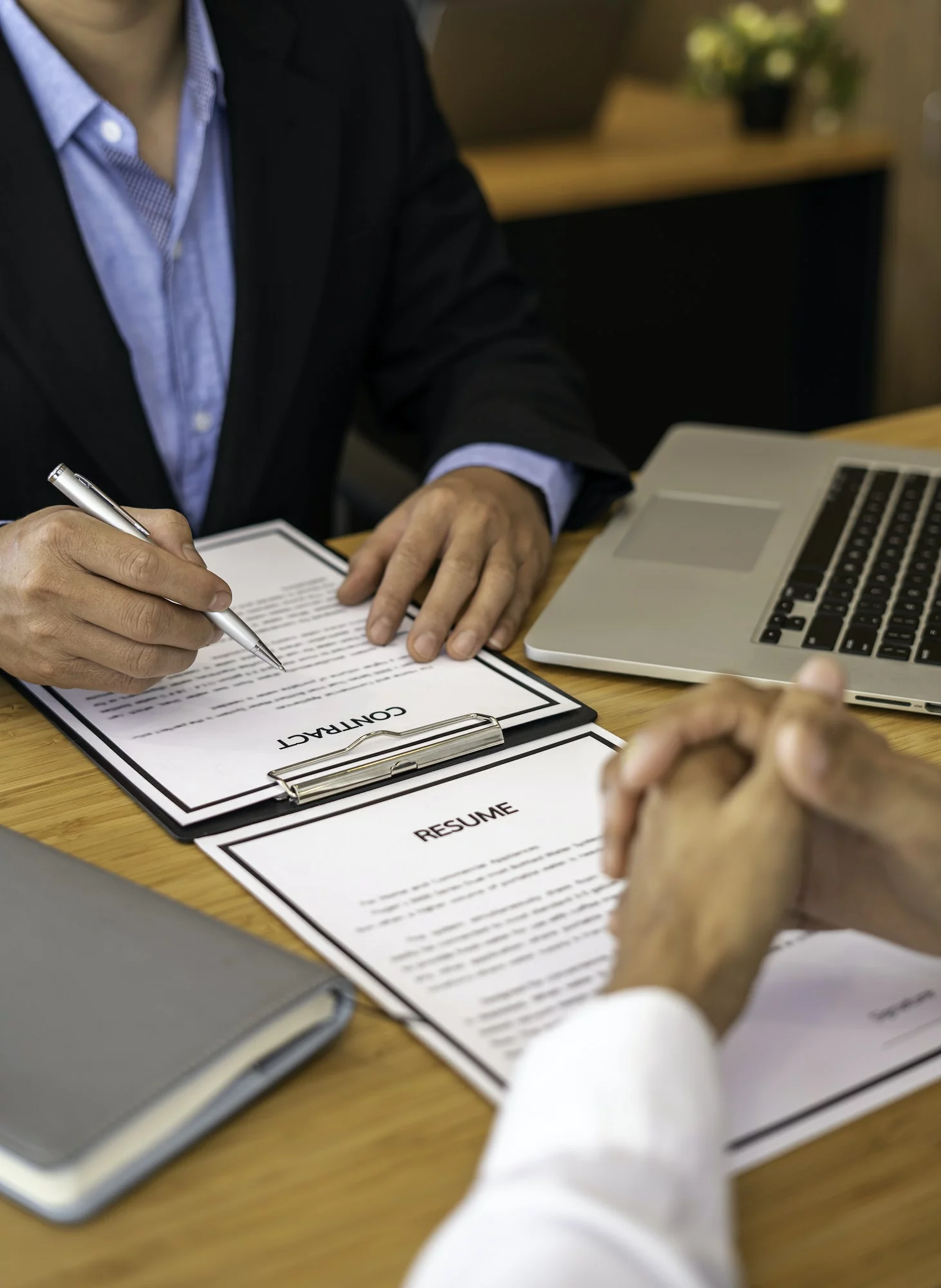 Human resources manager conducting job interview with applicant in the office, Candidate with resume