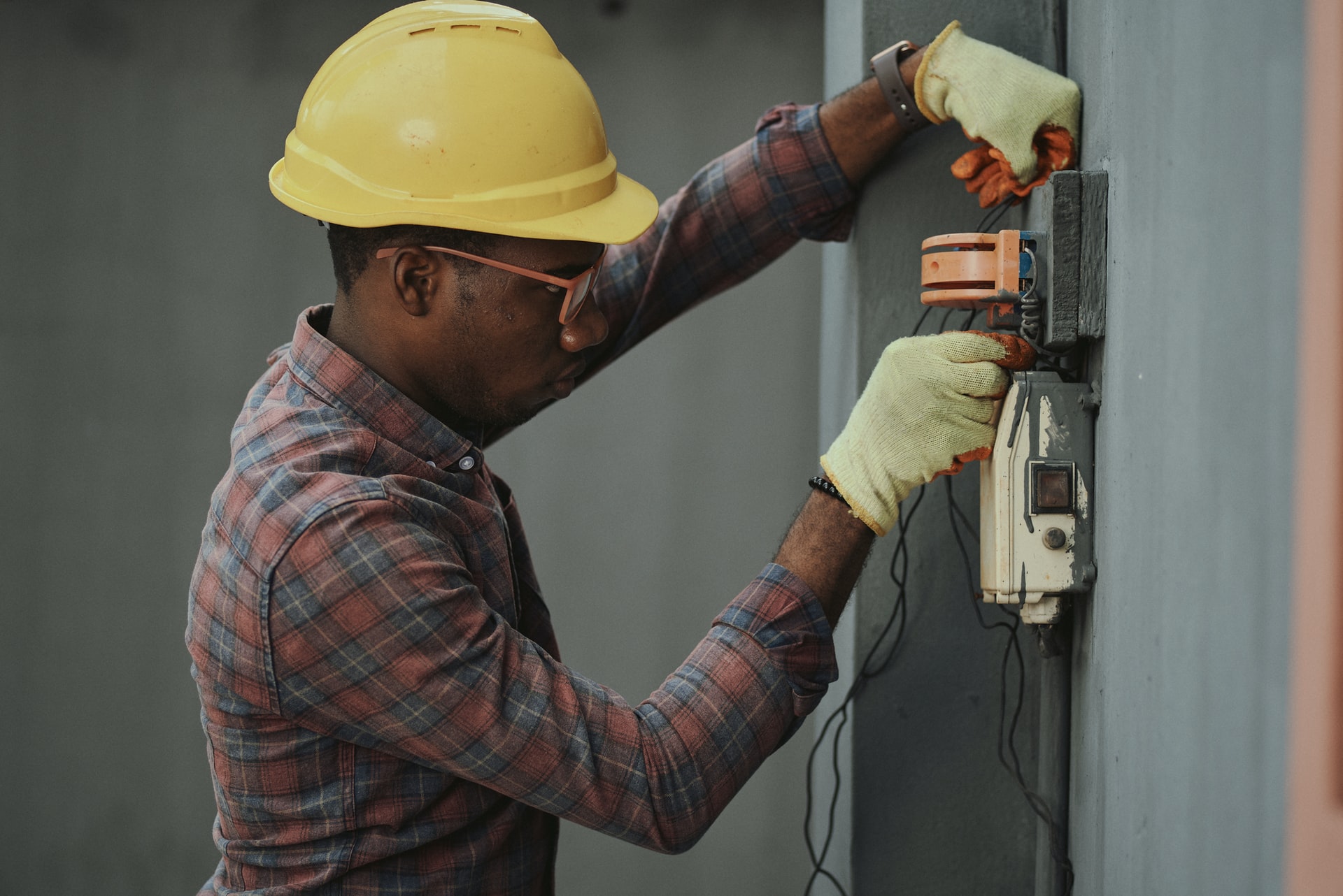 A man performing an electrical engineering job