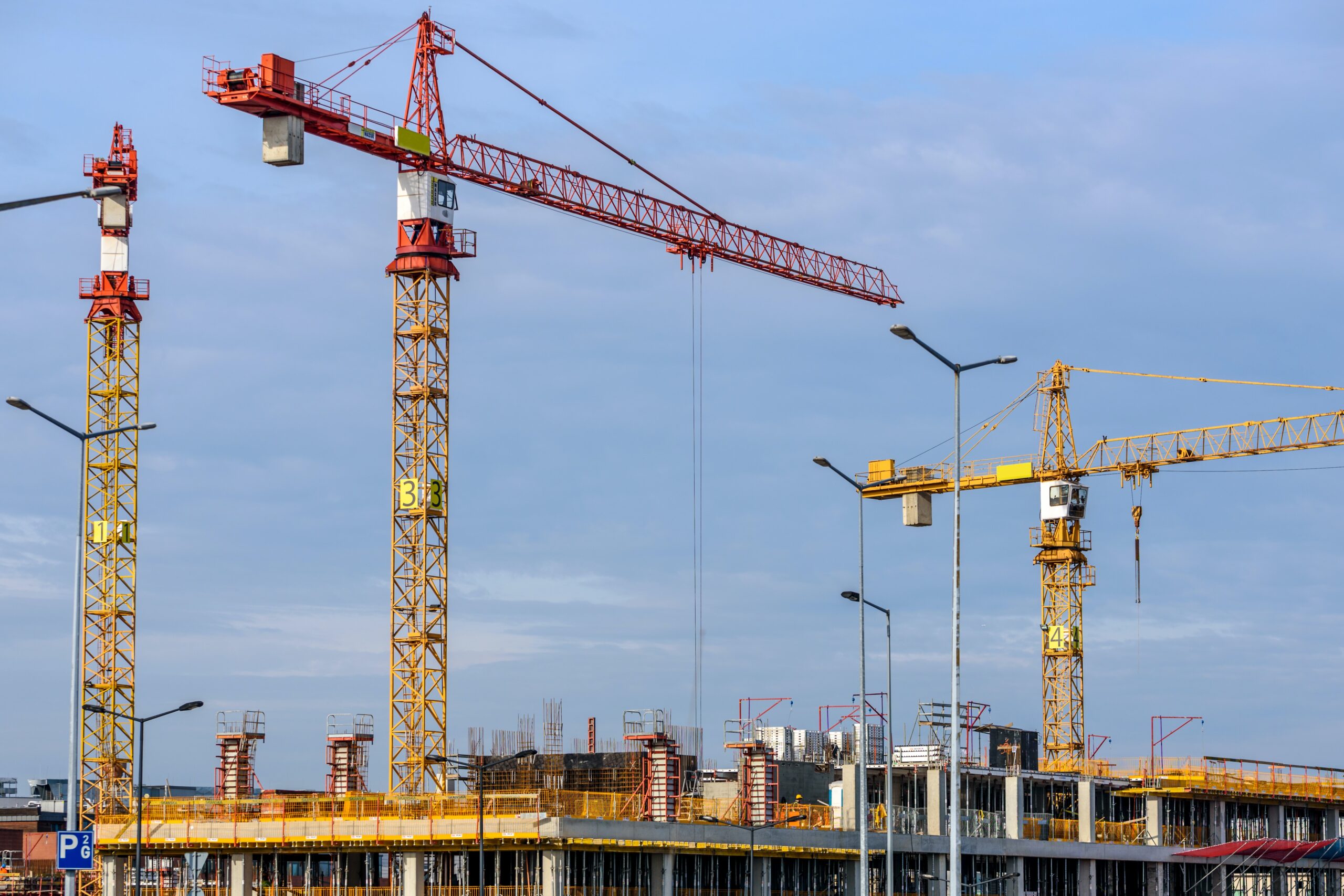 Three cranes over a construction site