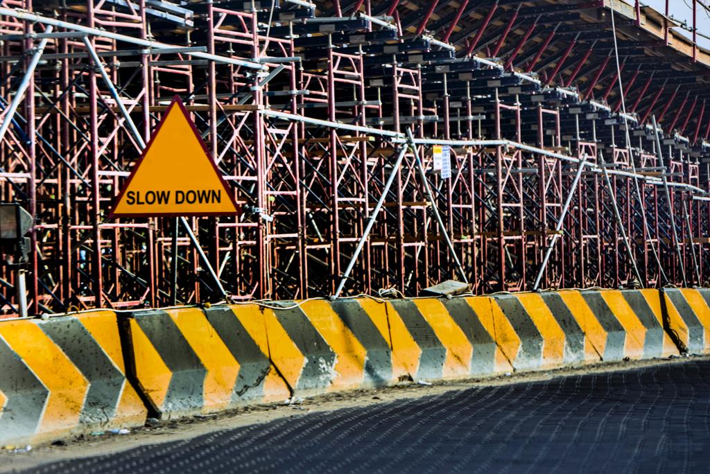 Construction scaffolding with a “slow down” sign