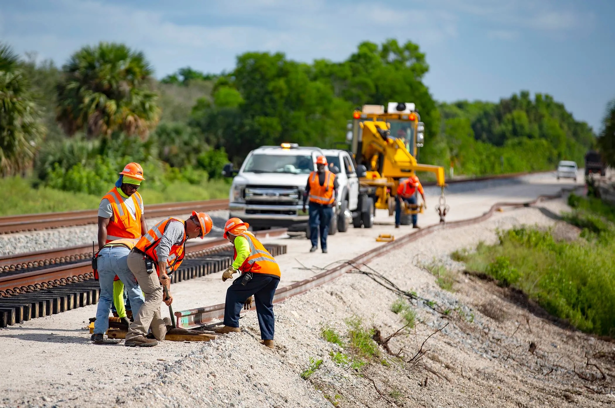 Construction crews position a rail