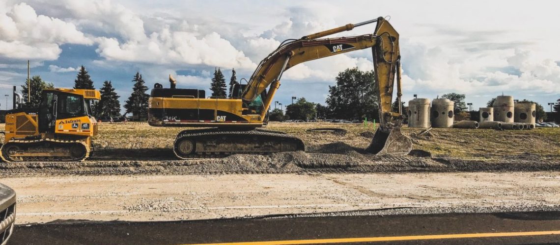 A large excavator digging a road-1200x900