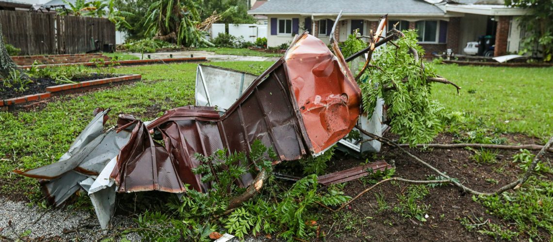 A mangled structure on a lawn destroyed by a natural disaster