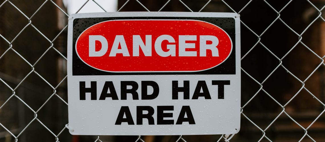 A danger sign on a chain link fence at a construction site