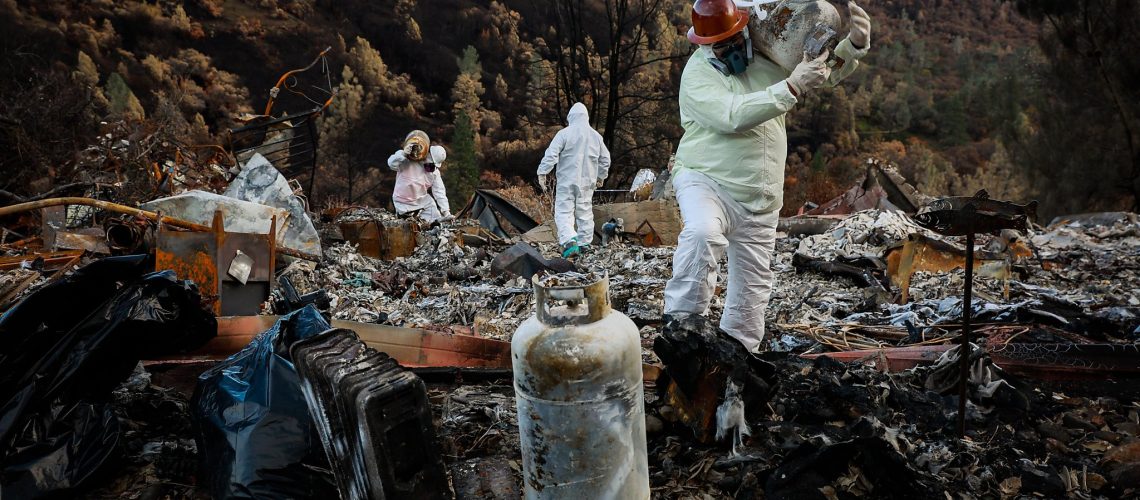 Fire cleanup crew in hazmat suites cleanup after a wildfire