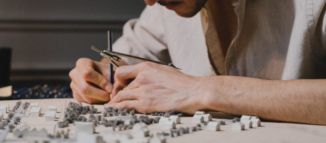 An architect working on an architectural model