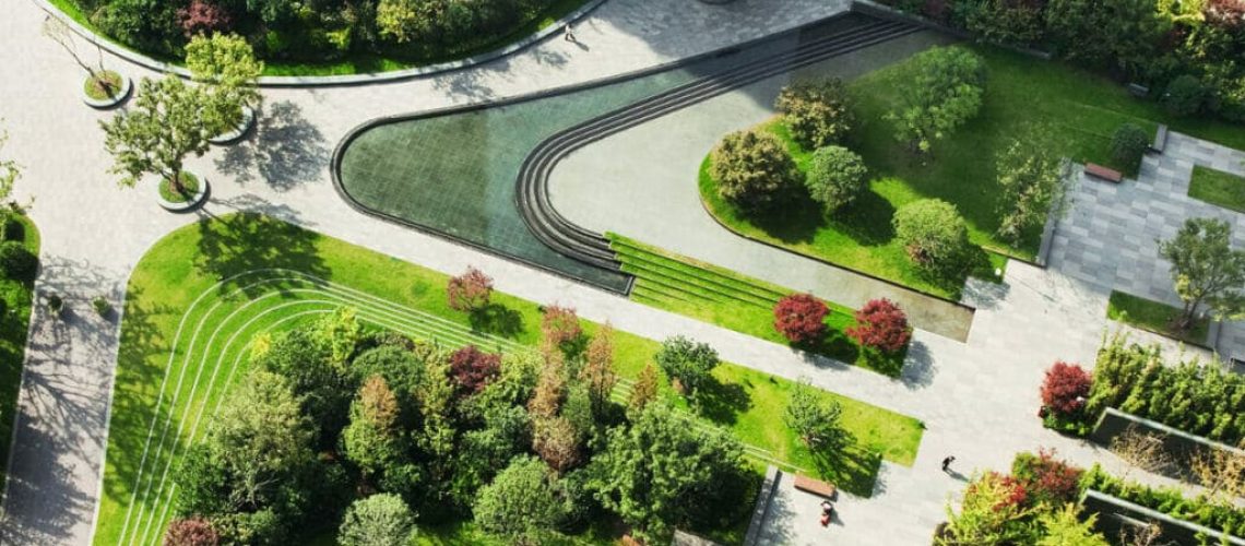 An intricately designed garden with flowers, trees, and paths.