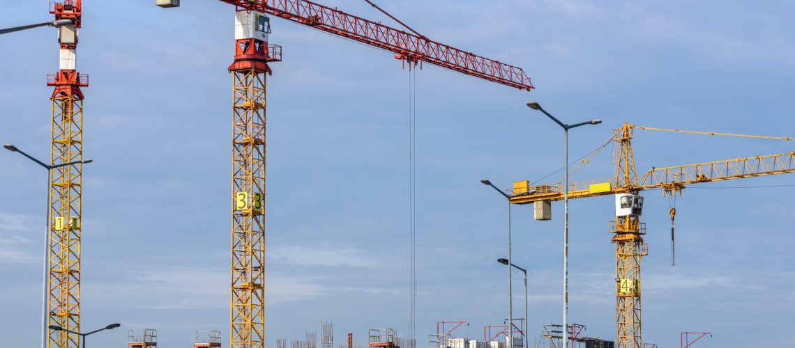Three cranes over a construction site