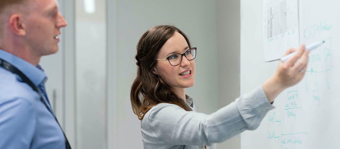 Two professionals discussing a presentation