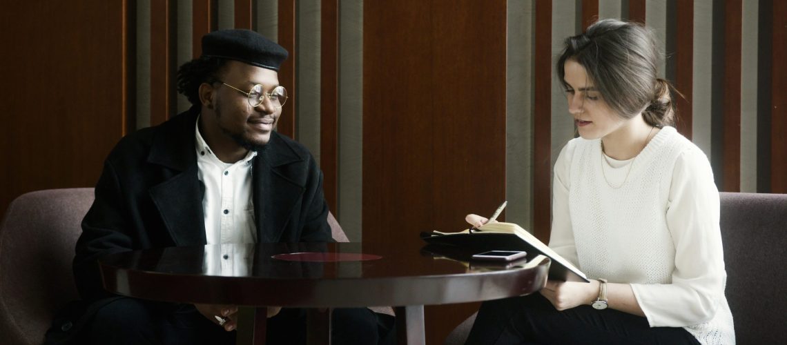 Two professionals look over a document