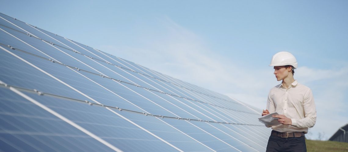 a professional inspecting solar panels