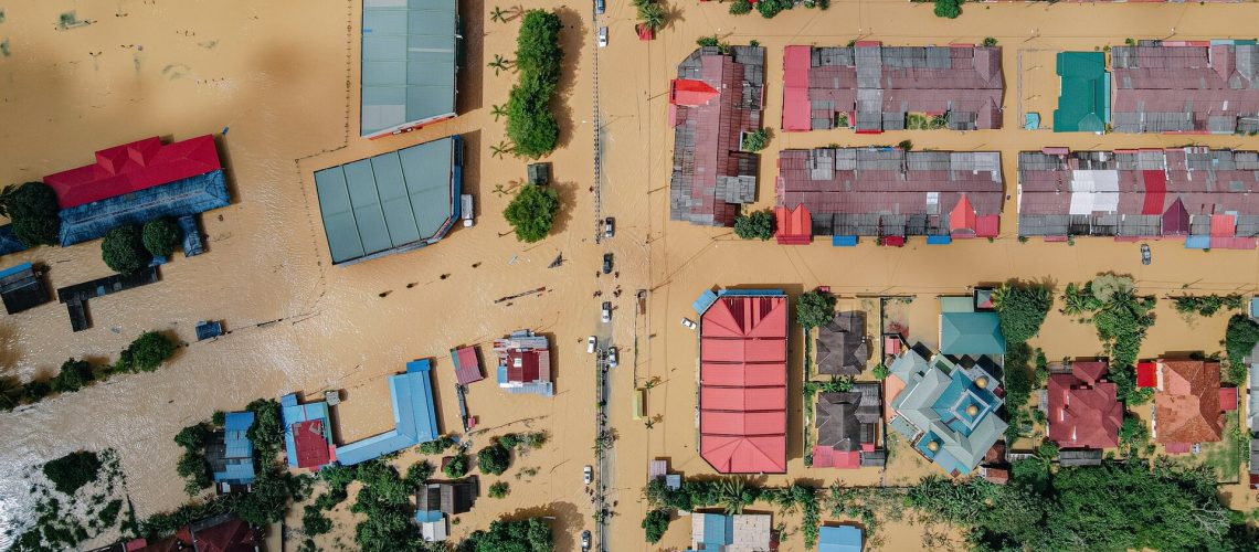 Overhead view of a community flooded with muddy brown water