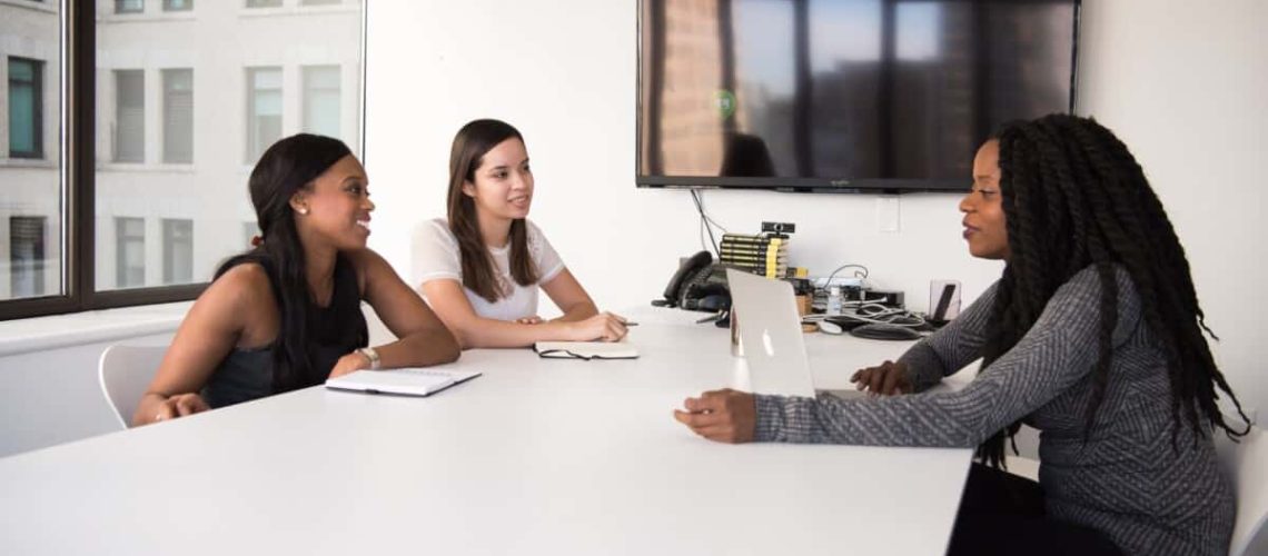 three businesswomen having a meeting in a boardroom