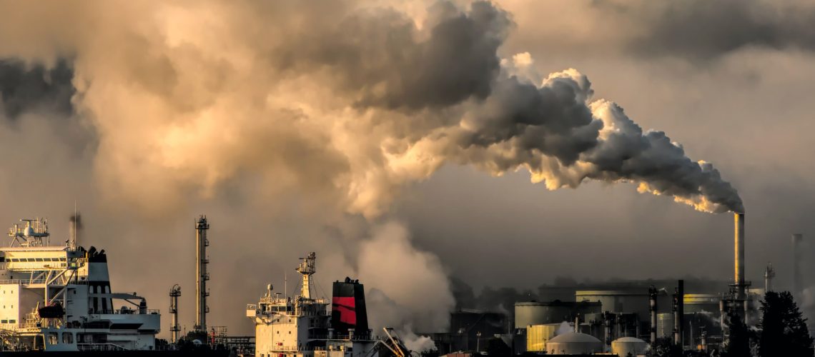 Smoke emitting from an industrial site near a harbor