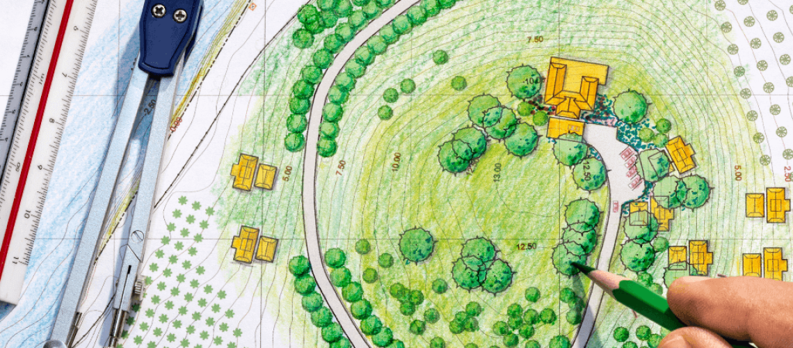 A landscape planner puts the finishing touches on a design for a house