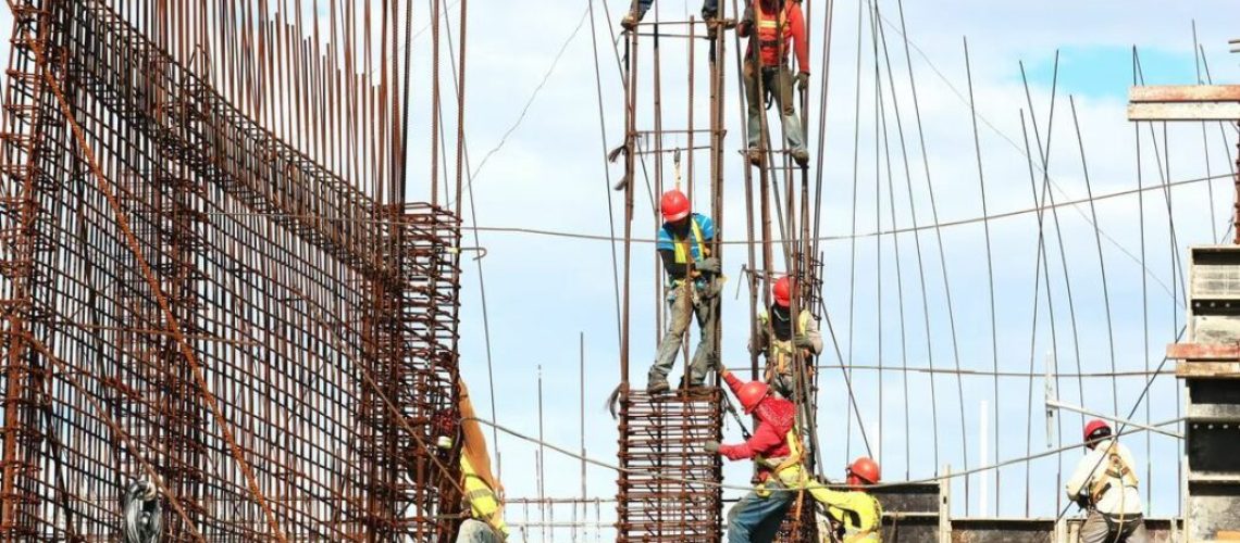 Construction materials testing technicians working on iron rods.